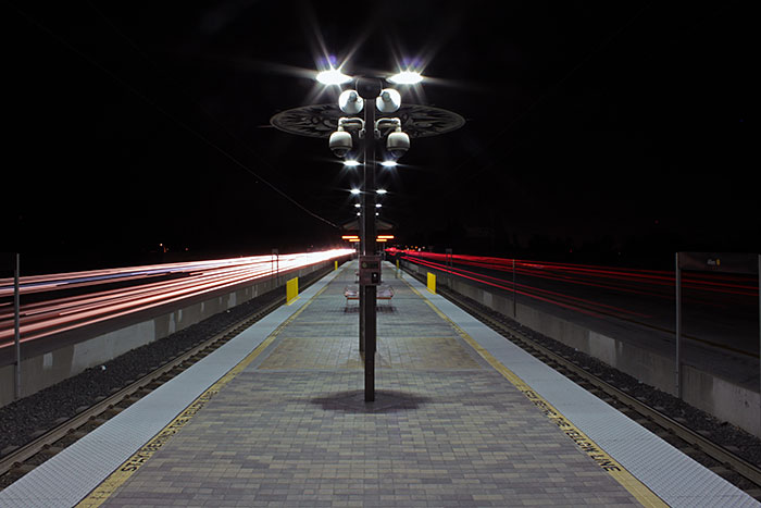 Traffic passing the empty Allen Station platform at
night